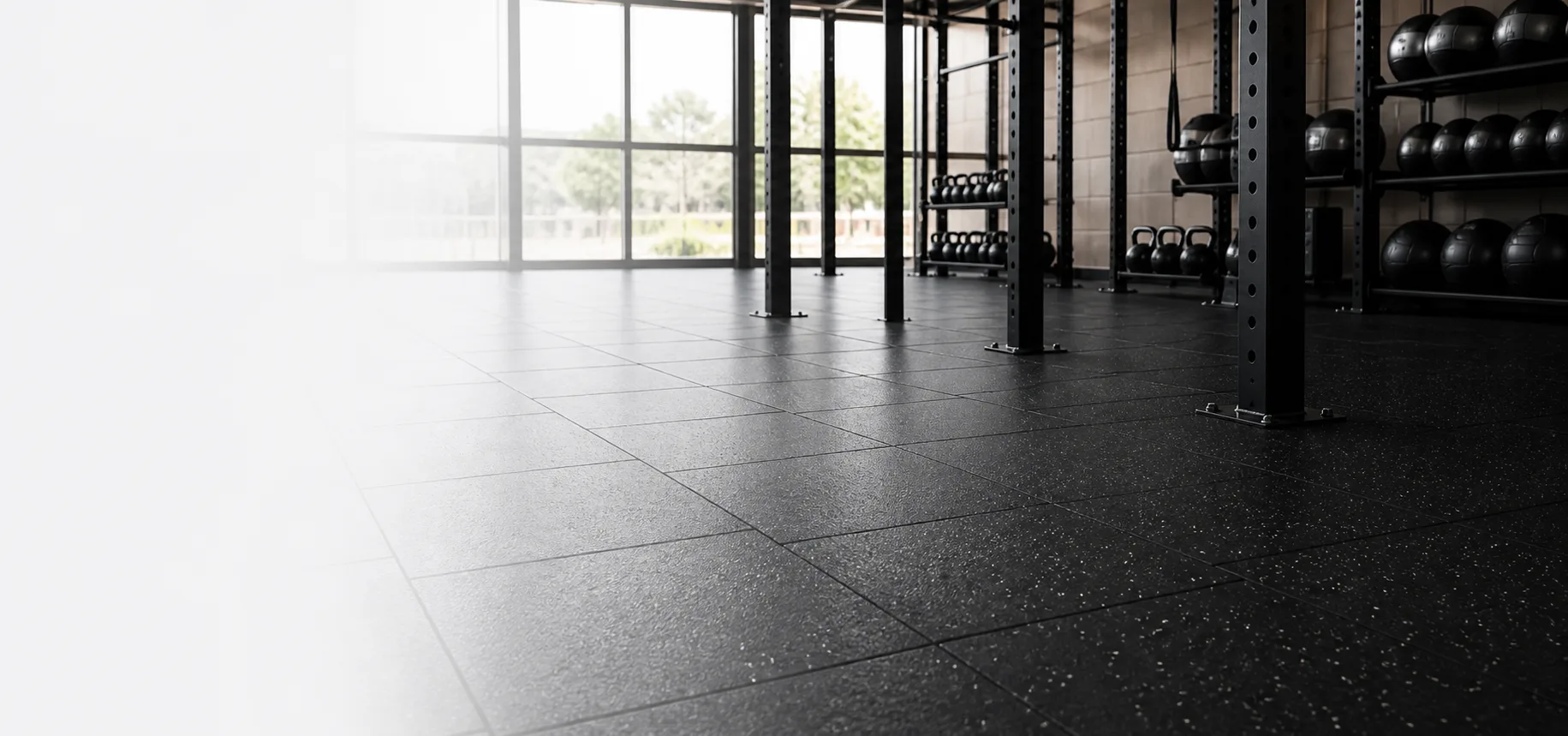 Premium black rubber flooring installed in a modern strength-training gym